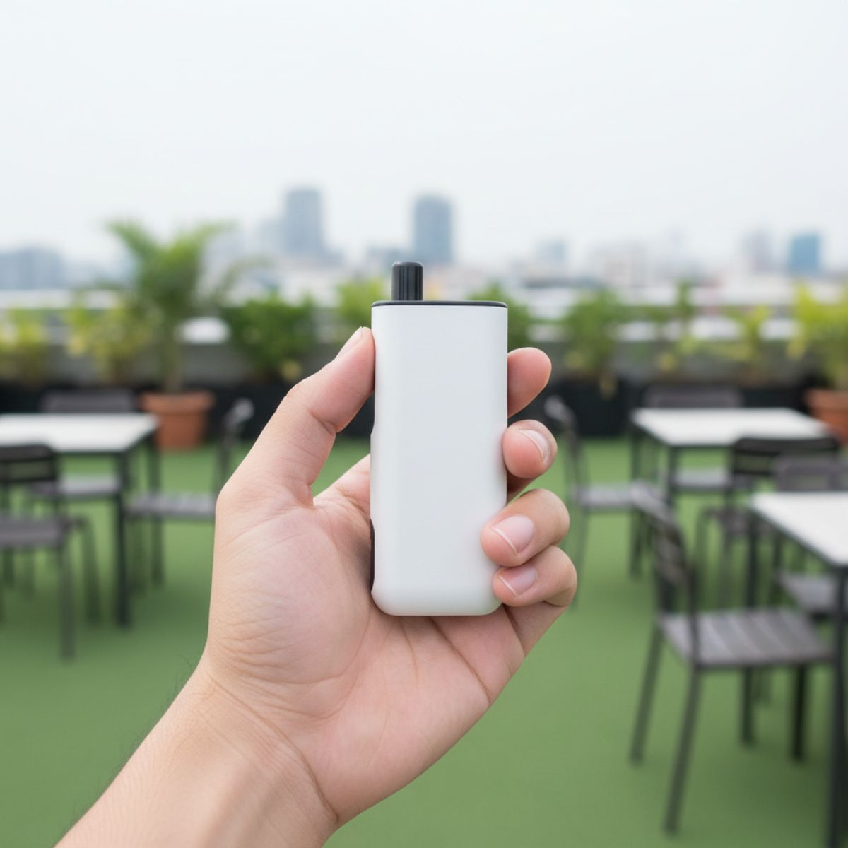 Person holding a Matte White AirsPops ORKA in their hand on a rooftop