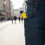 AirsPops ONE USE 6ml disposable vape partially visible in a jeans pocket while walking in a city street