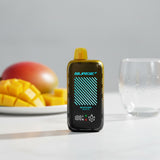Mango Ice Nasty Bar Surge 55k Disposable Vape on a table with a mango in the background and an empty cup