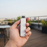 Person holding Matte White AirsPops Pro II on a rooftop