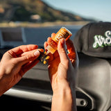 Woman refilling AirsPops Pro refillable pods with 313 AirsPops e-liquid 